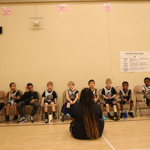 a group of kids sitting in chairs in a room