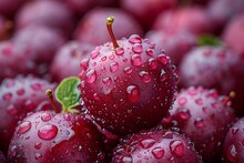 a group of red cherries with water droplets on them