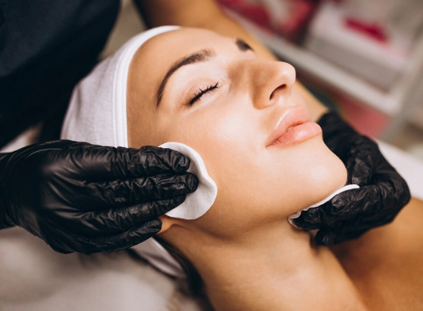 a woman with black gloves and white head wrap