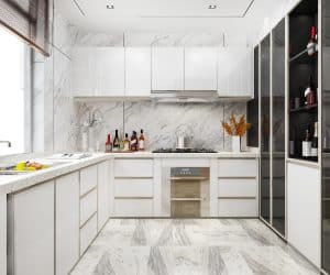 a kitchen with white cabinets and marble floor