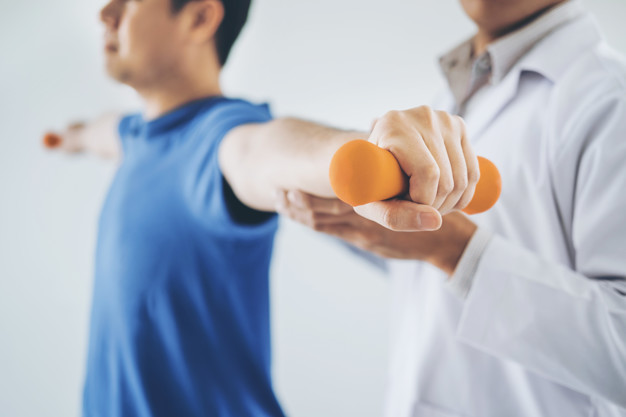 a man lifting weights with a doctor