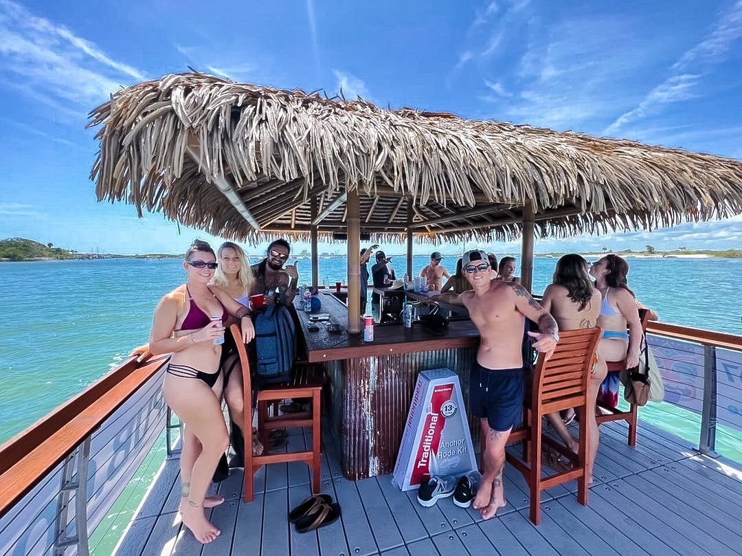 a group of people sitting at a bar on a dock