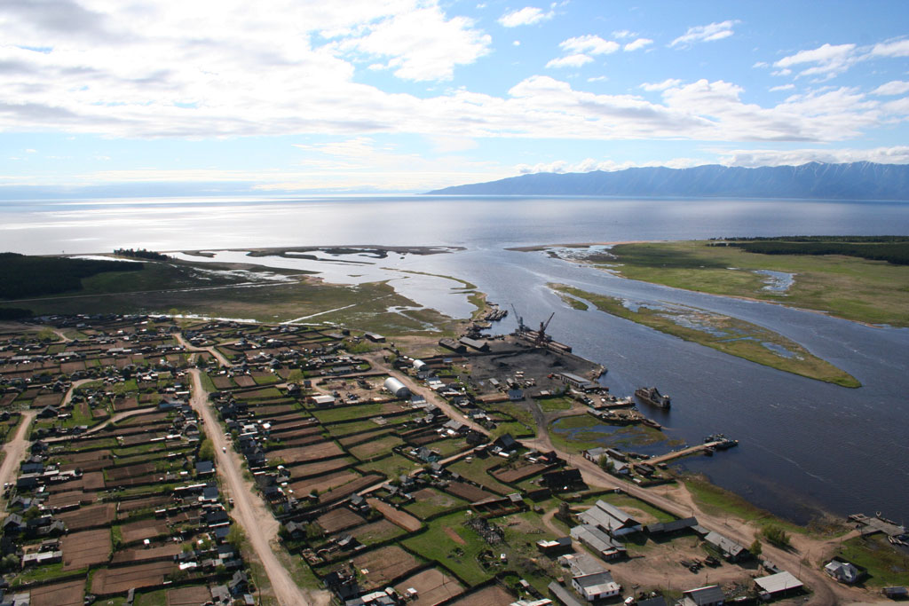 a aerial view of a town by a body of water