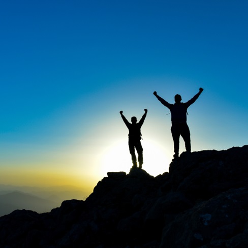 a group of people standing on a mountain