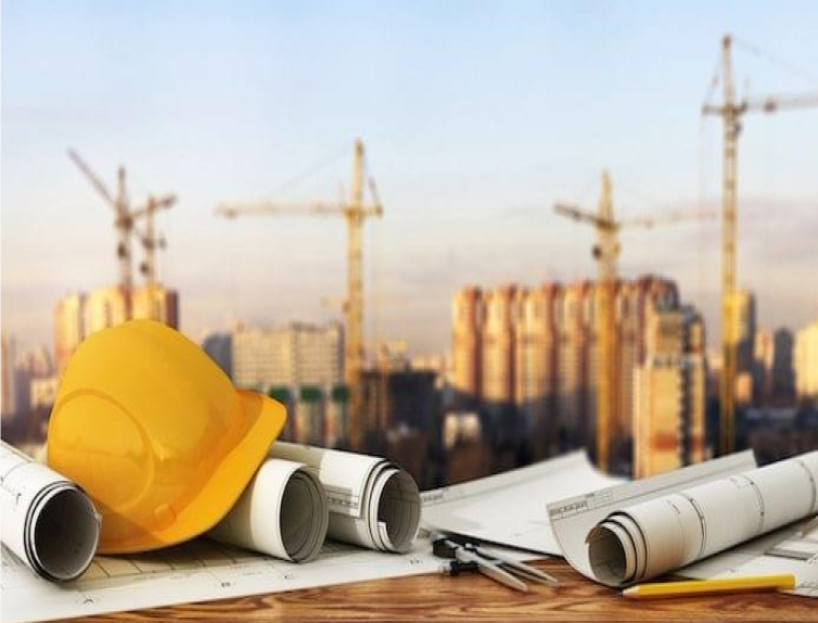 a hard hat and blueprints on a table