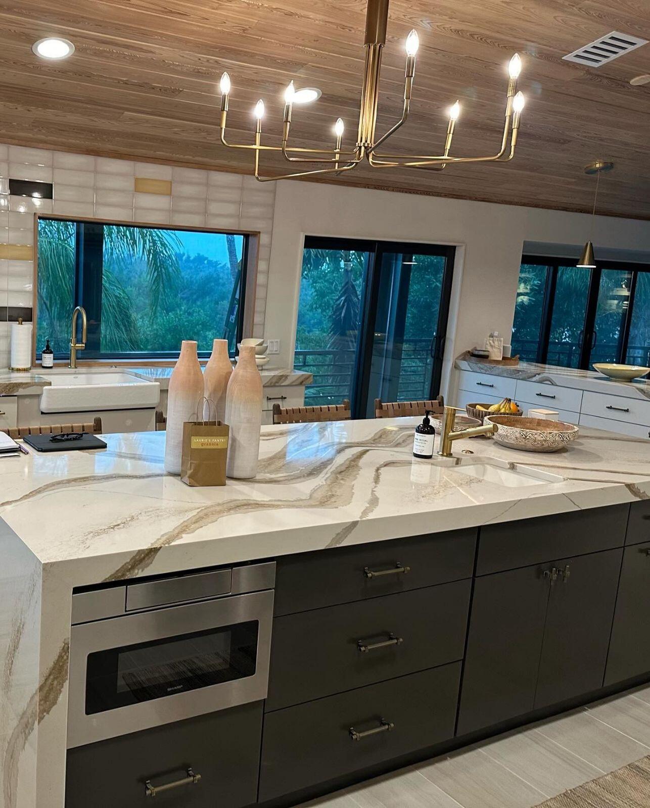 a kitchen with a chandelier and a large island