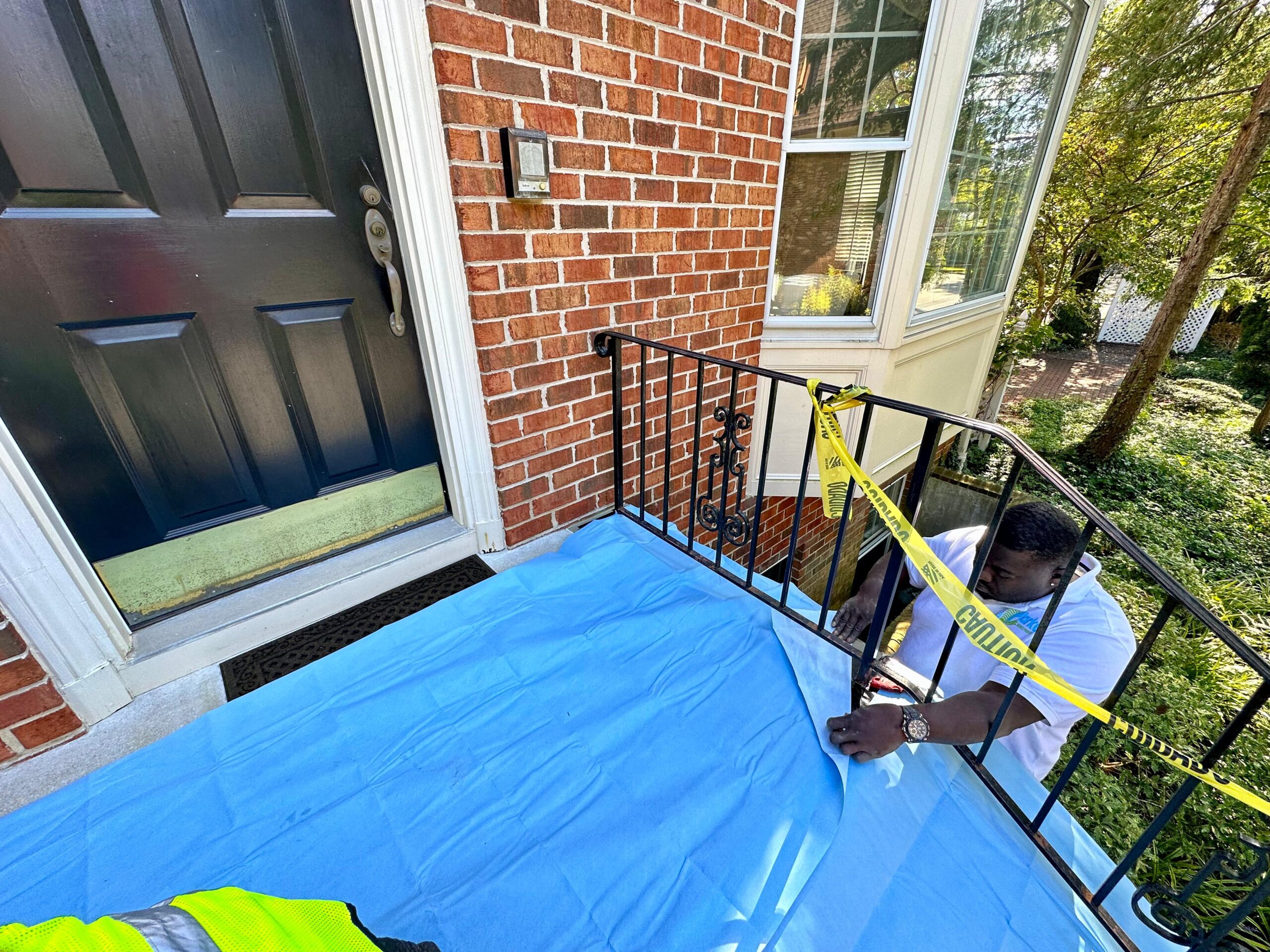 a man painting a porch