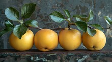 a group of yellow fruits with green leaves