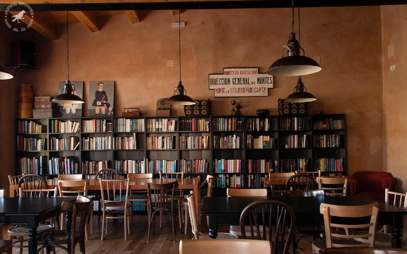 a room with bookshelves and tables