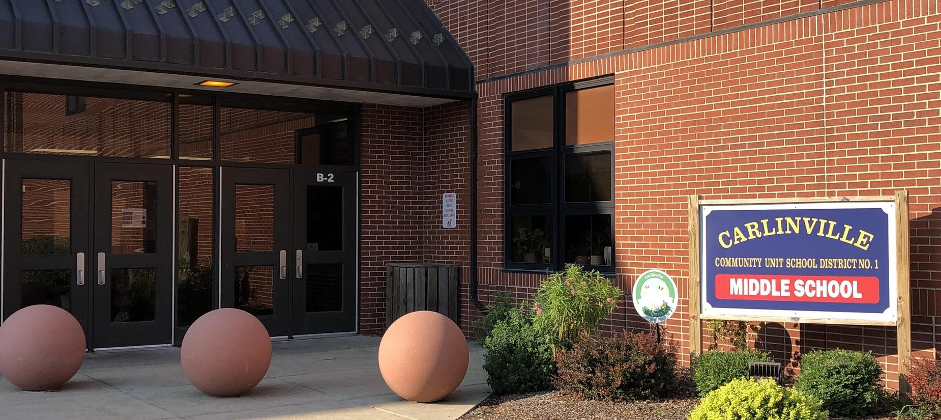 a brick building with large balls outside