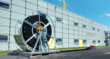 a large cable reel outside a building