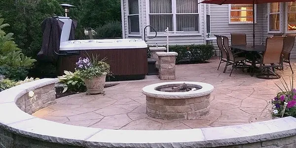 a patio with a hot tub and a hot tub