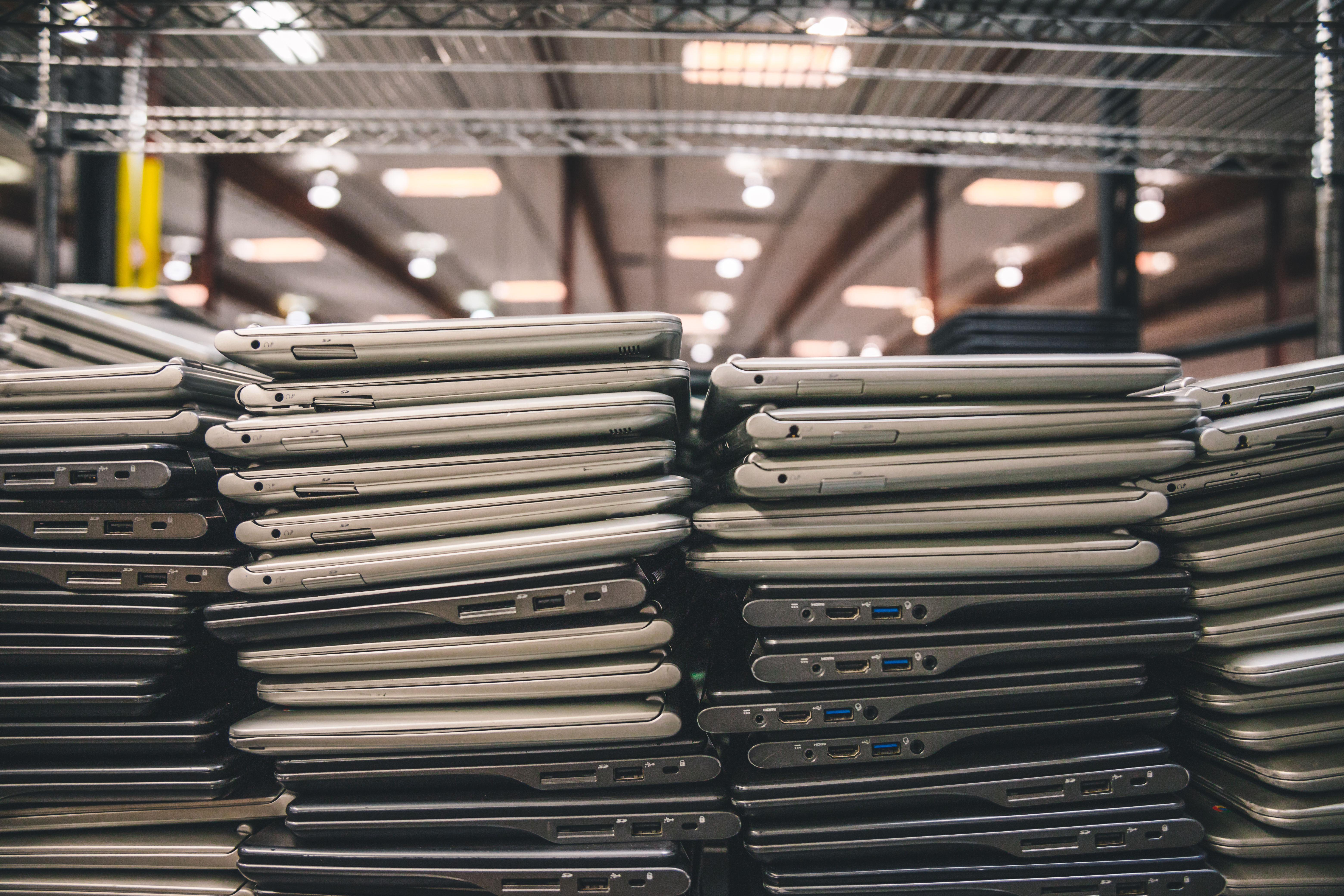 a stack of laptops in a warehouse