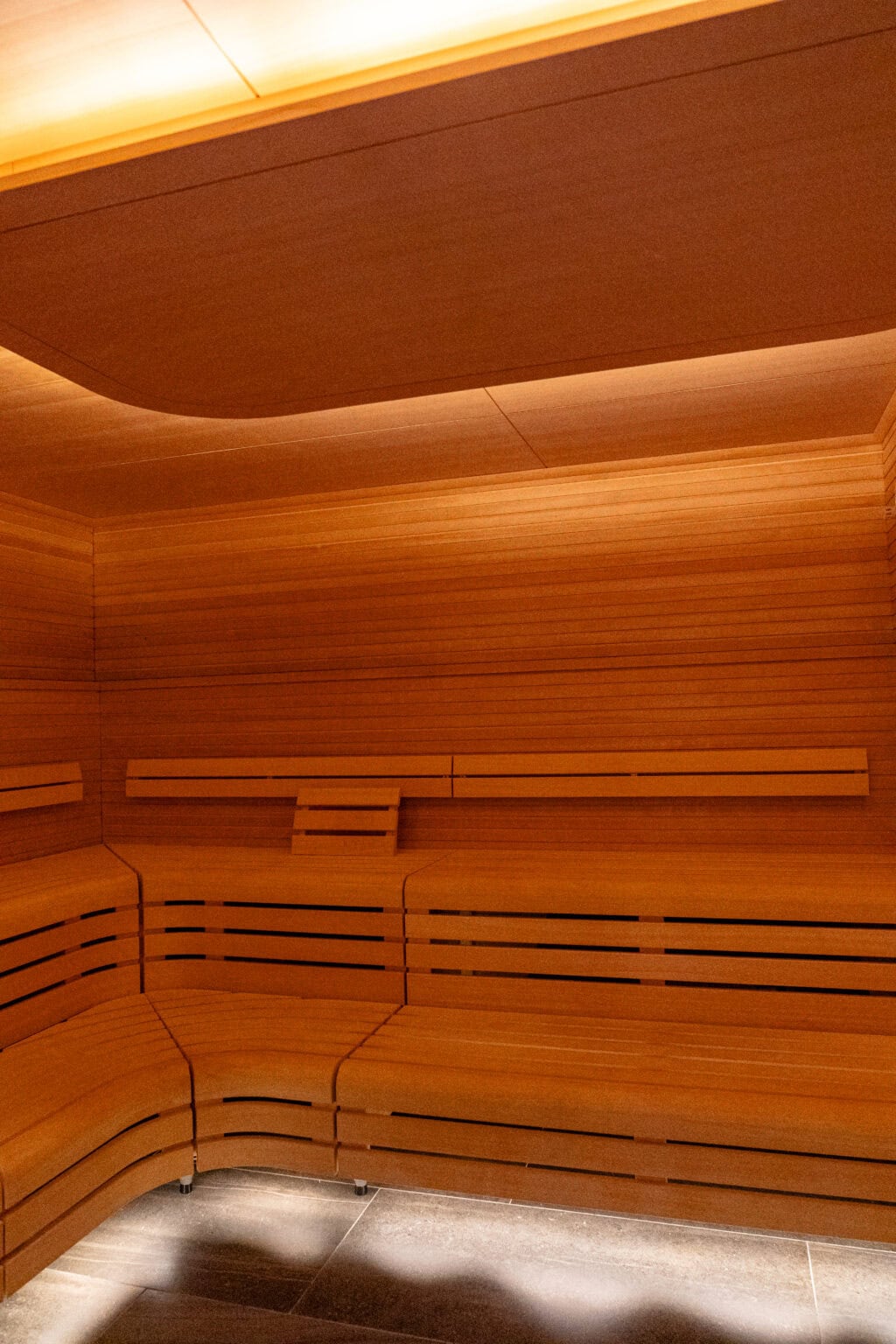 a wooden sauna with a light on the ceiling