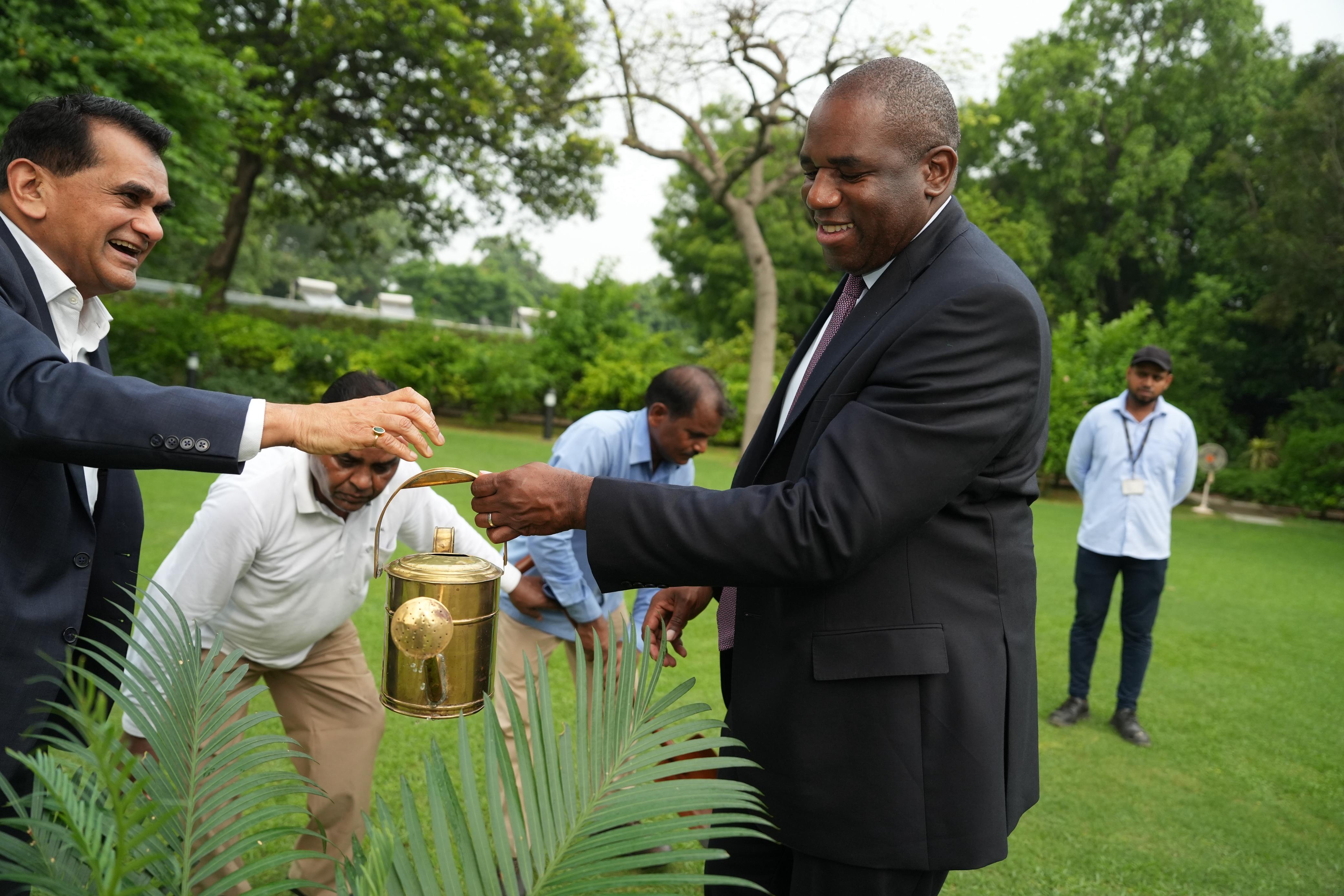 a man pouring a drink into a can