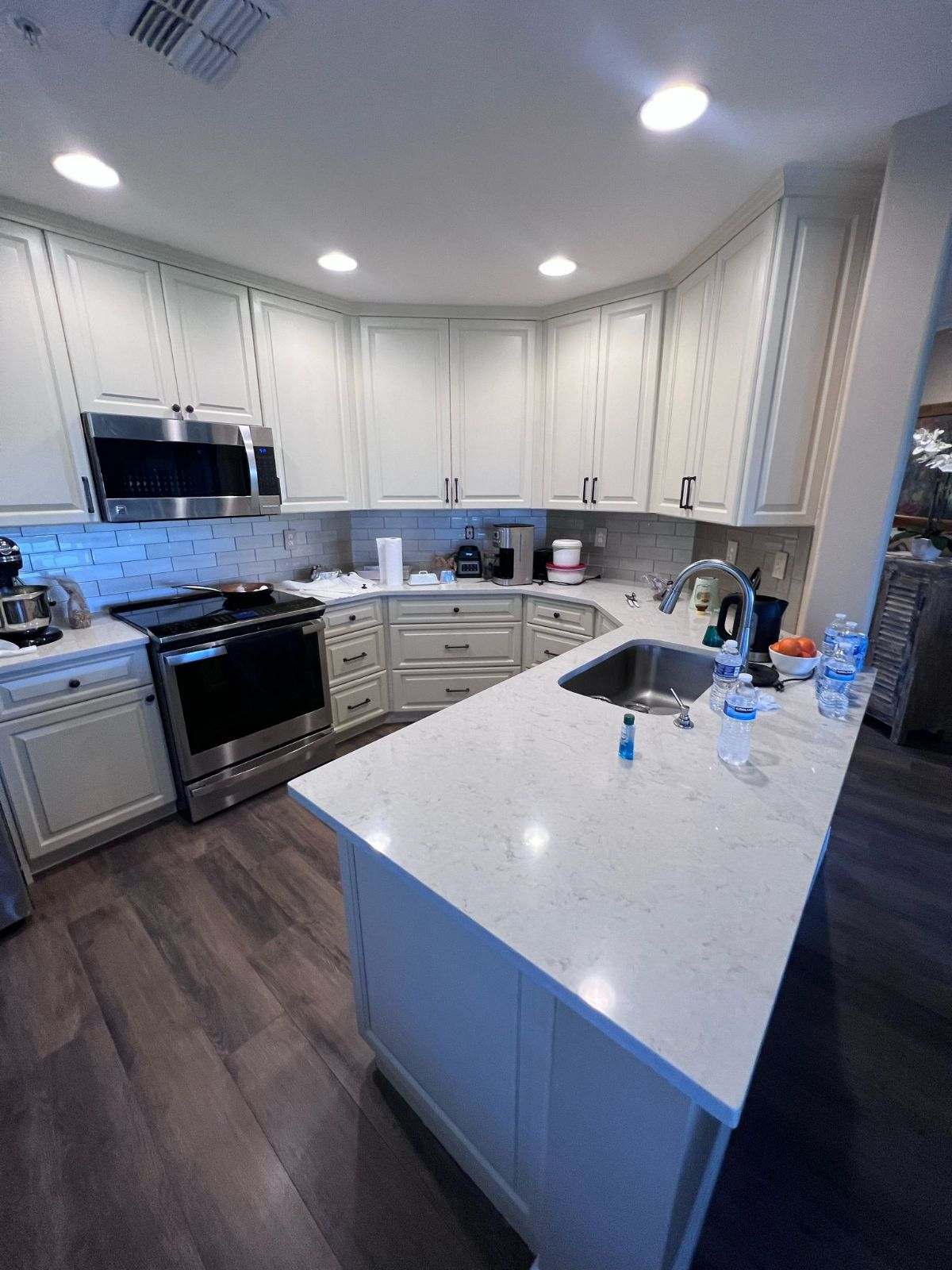 a kitchen with white cabinets and white counter tops