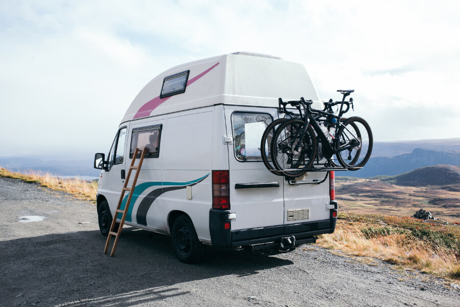a white van with bicycles on the back
