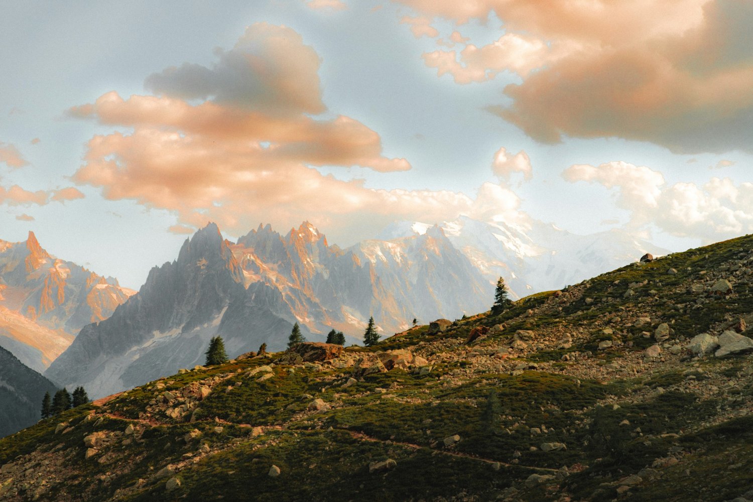 a mountain landscape with trees and mountains in the background