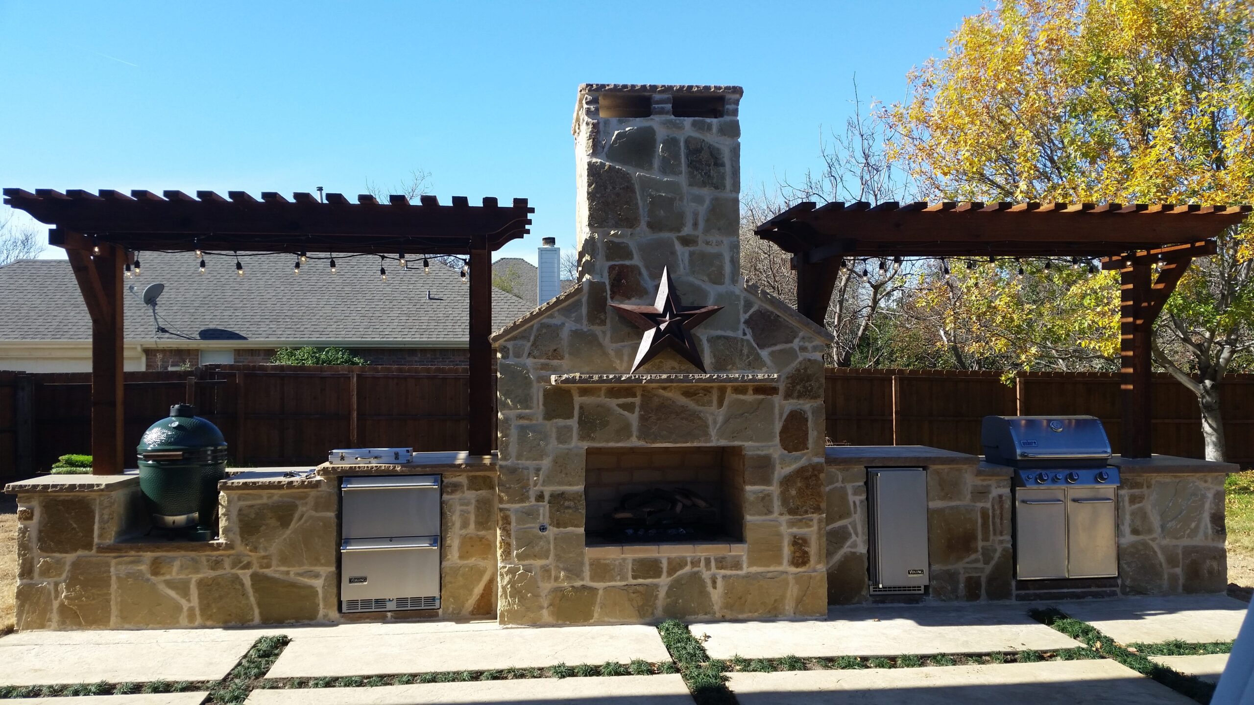 a stone outdoor fireplace with a star on top