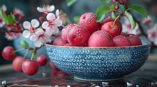 a bowl of fruit with flowers