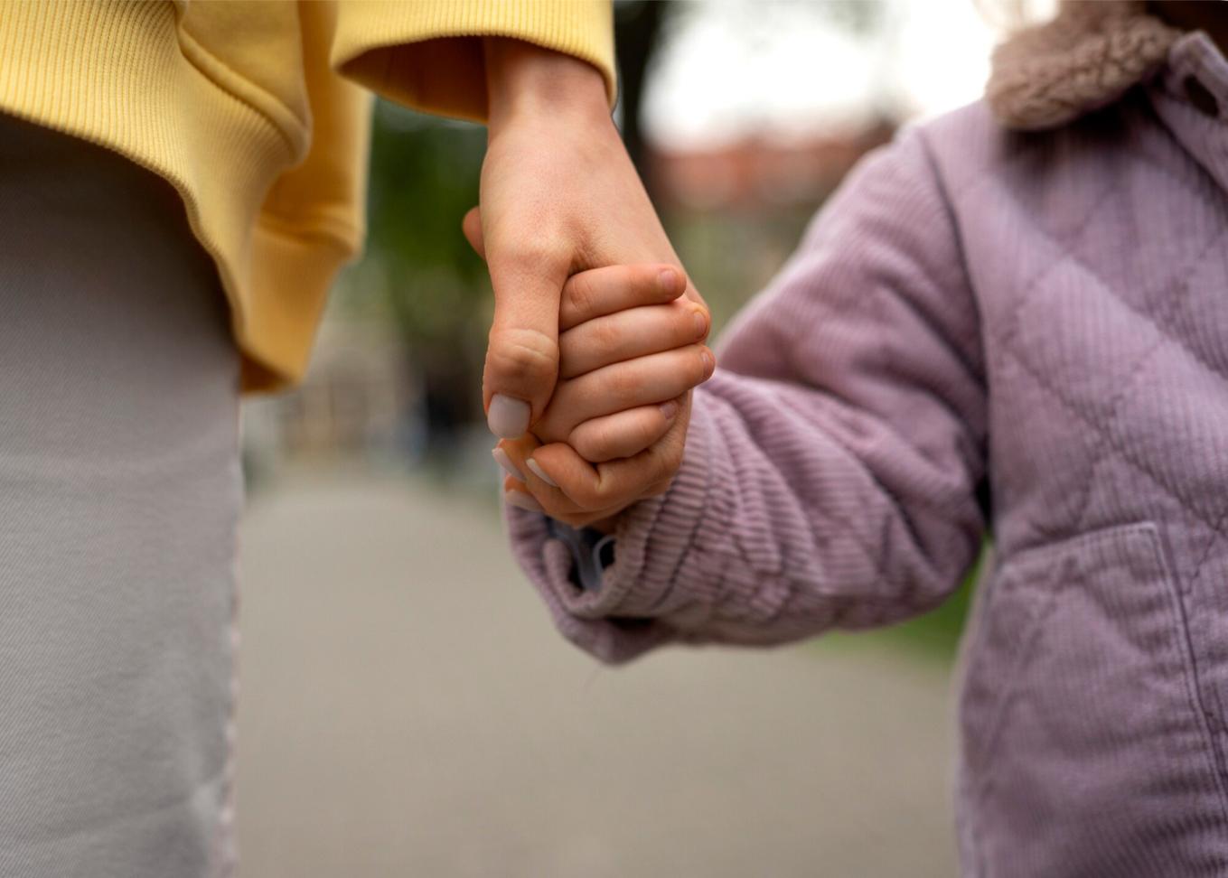 a close up of a hand holding a child