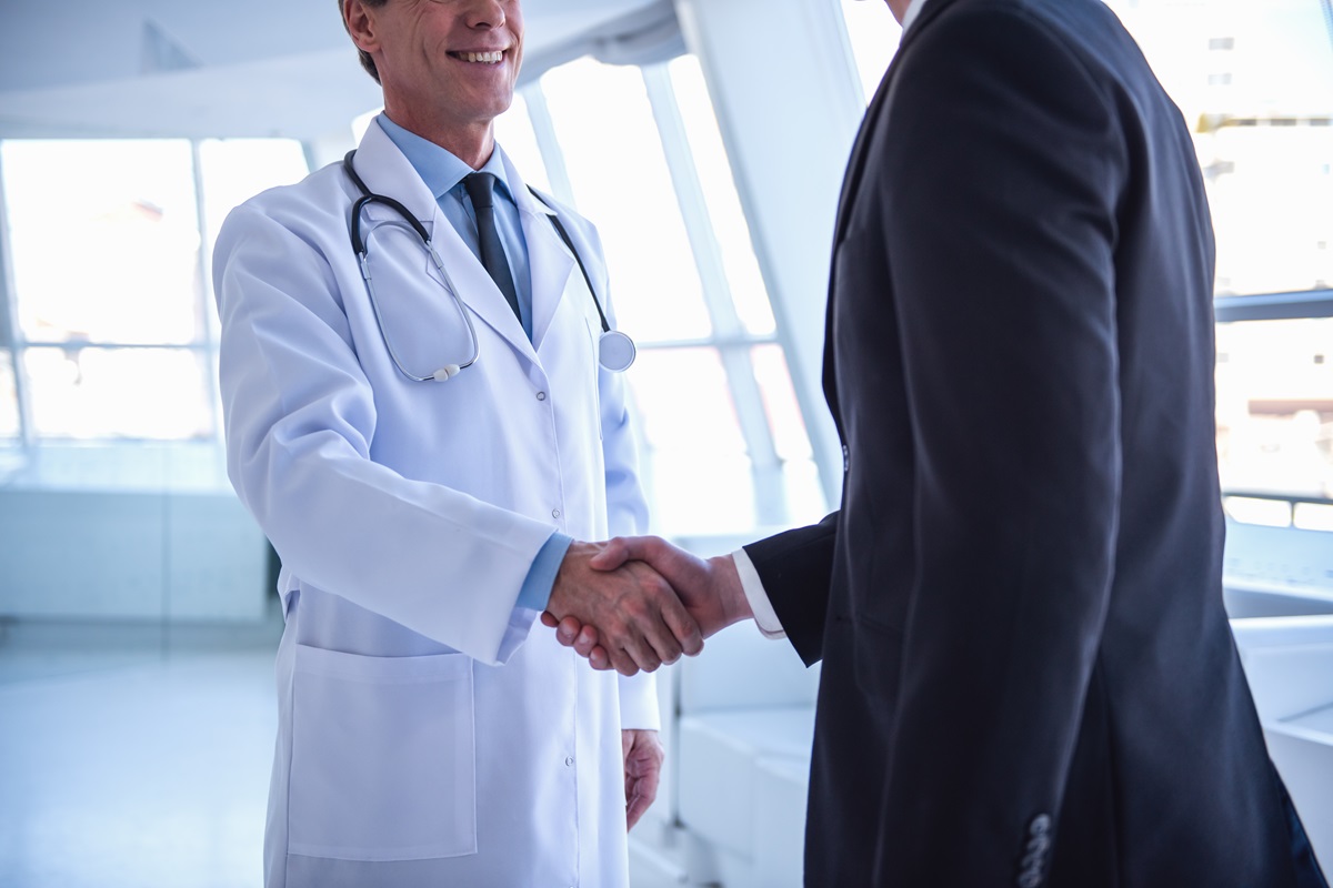 a doctor shaking hands with a man