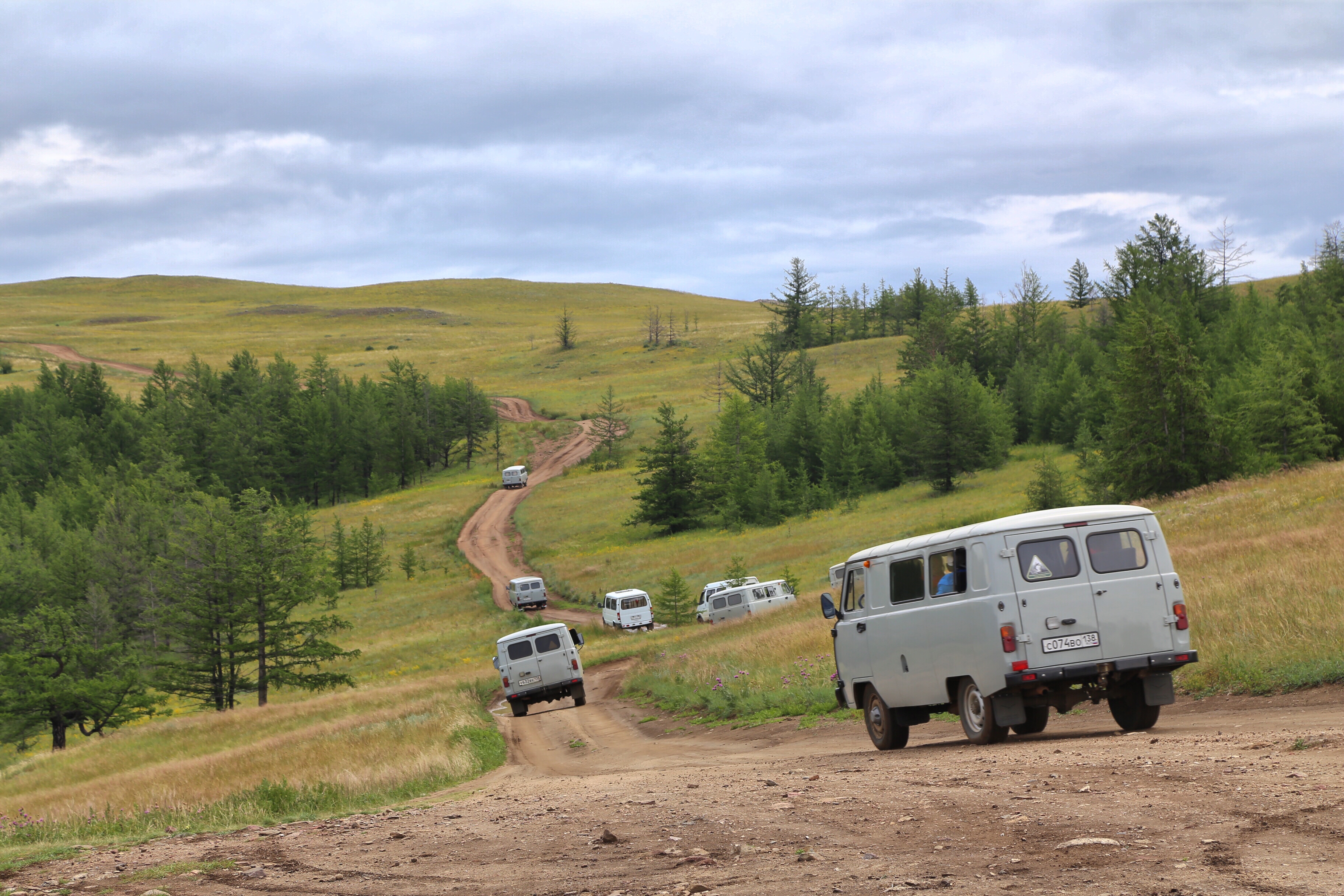 a group of vehicles on a dirt road