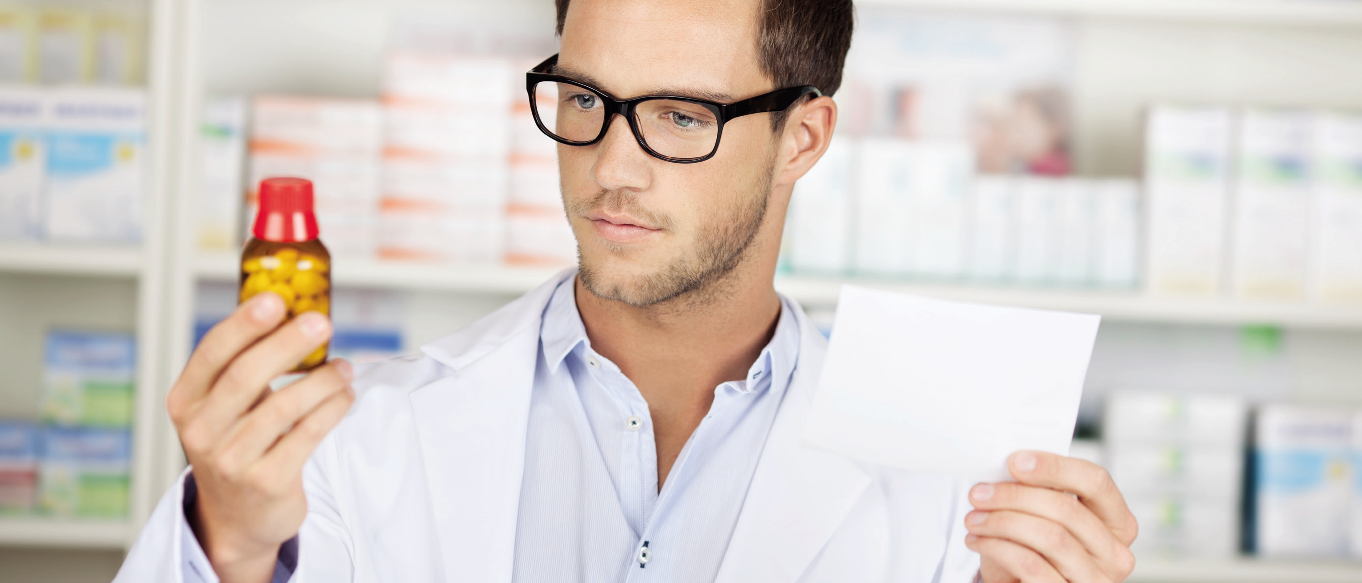 a man in glasses holding a piece of paper