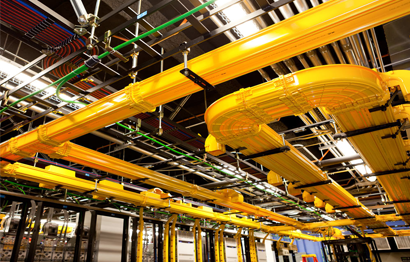 yellow pipes and wires in a factory