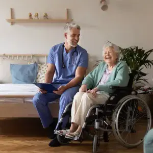 a man in a blue scrubs and a woman in a wheelchair