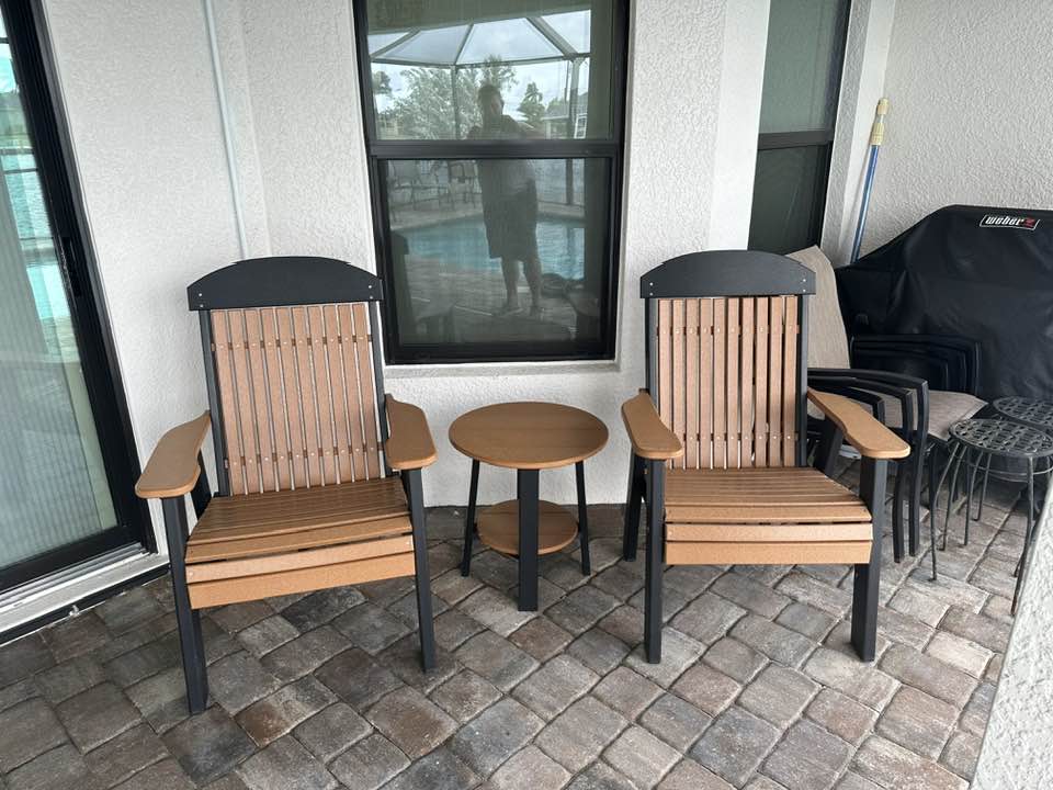 a group of chairs and a table on a brick patio