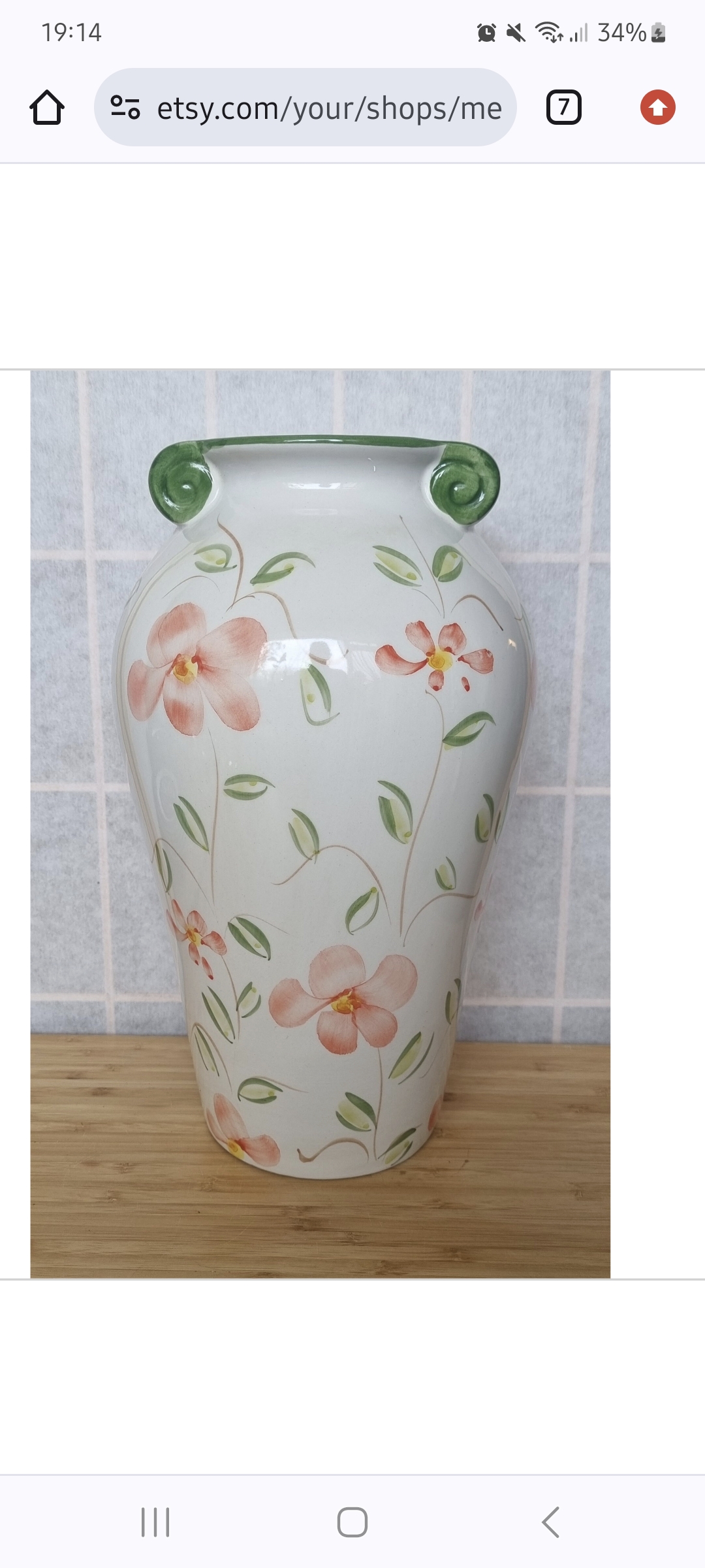 a vase with flowers painted on it
