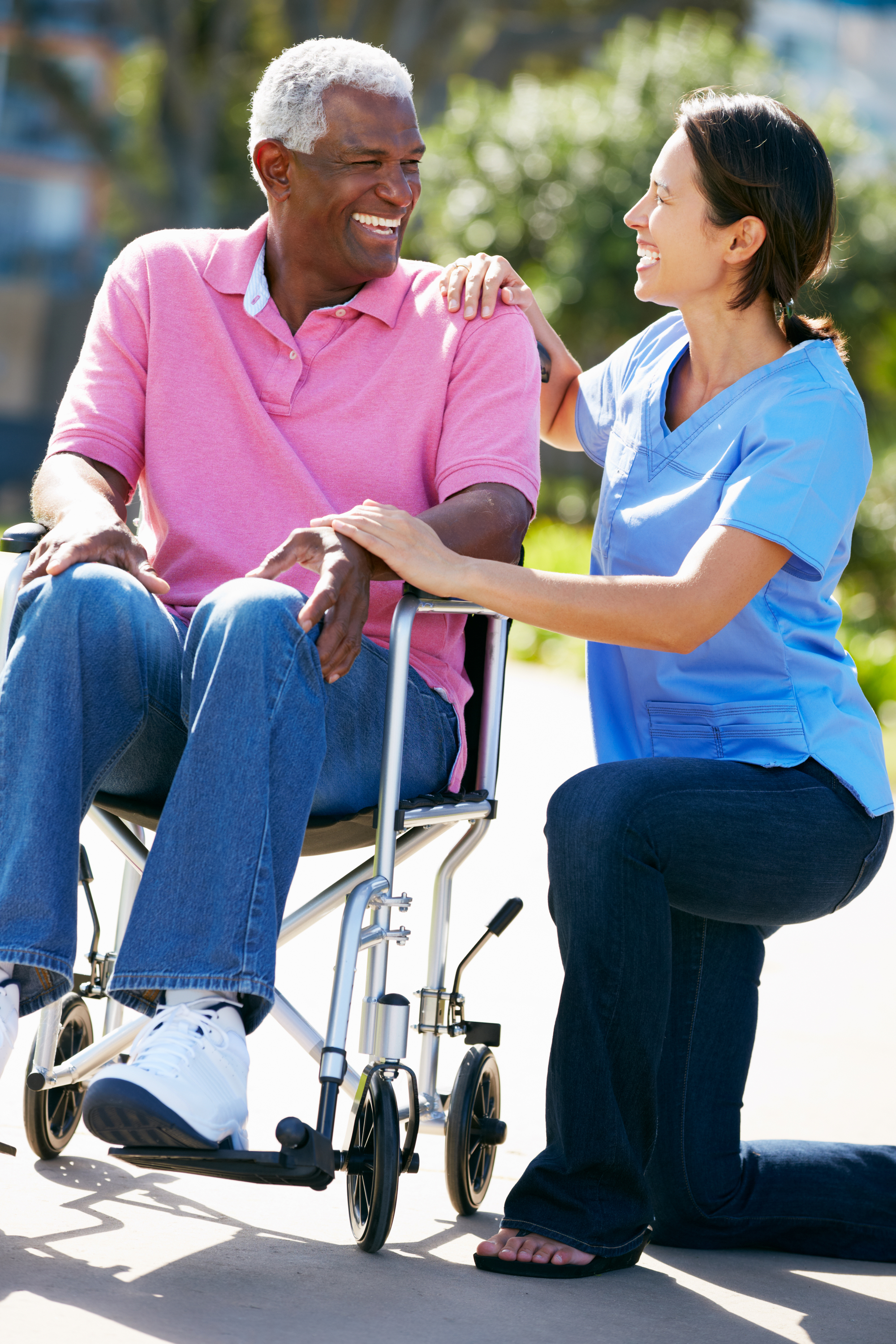 a nurse helping a man in a wheelchair