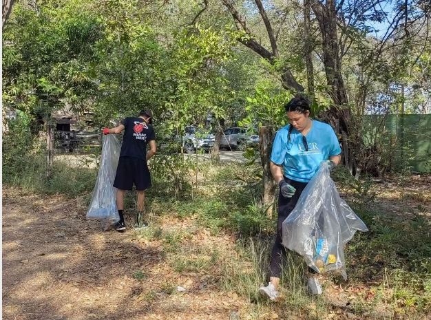a couple of people picking up trash