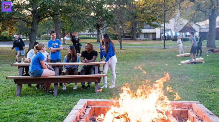 a group of people sitting around a picnic table