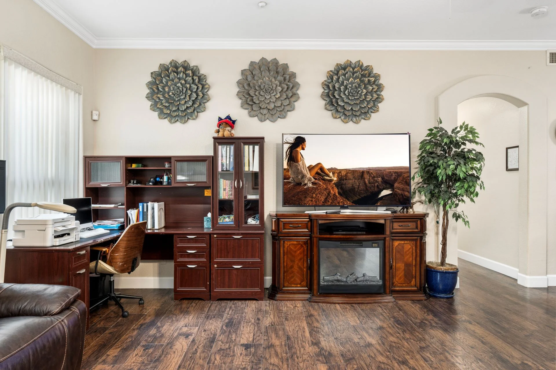 a room with a television and a desk