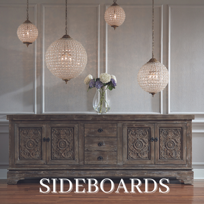 a sideboard with flowers and chandeliers