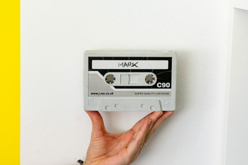 a hand holding a cassette tape