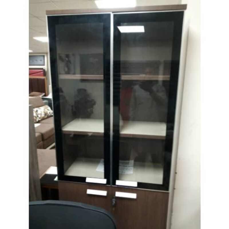 a glass cabinet with a black glass door