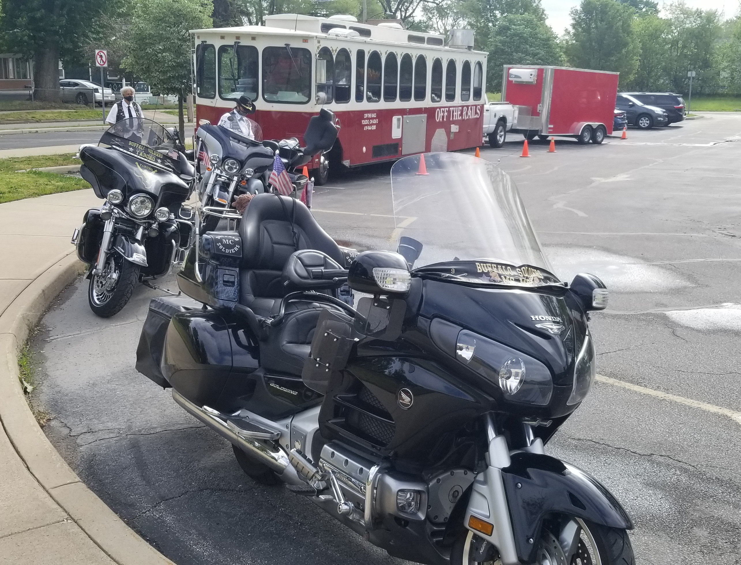 a group of motorcycles parked in a parking lot