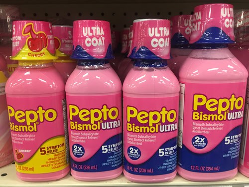 a group of pink bottles on a shelf