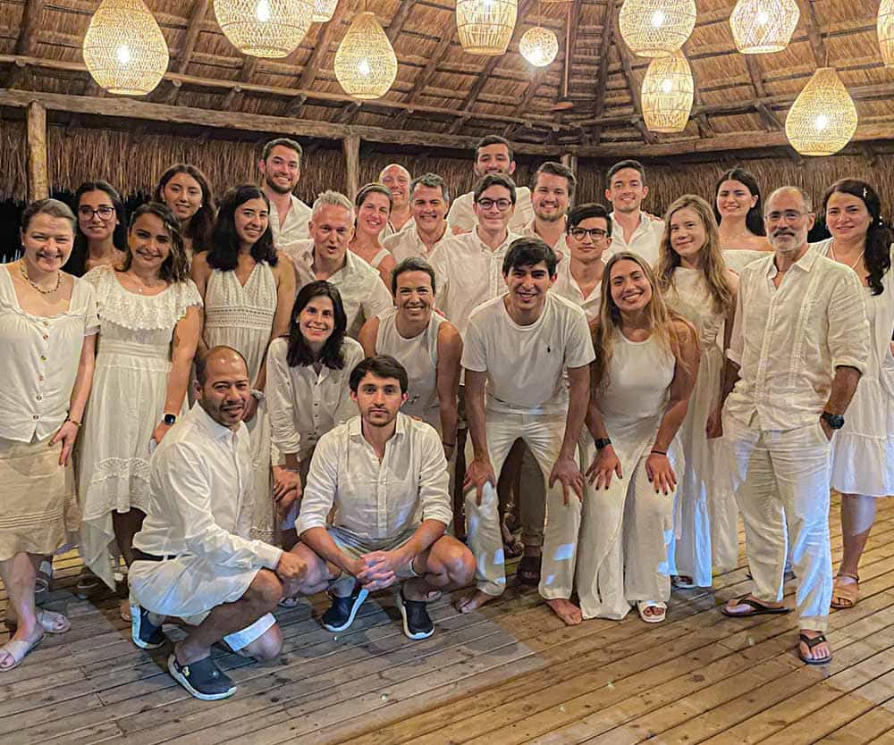 a group of people in white outfits posing for a photo