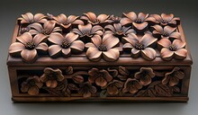 a wooden box with flowers carved on it