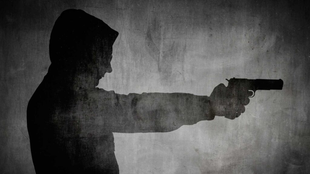 a silhouette of a person holding a gun