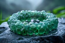 a green bracelet on a rock