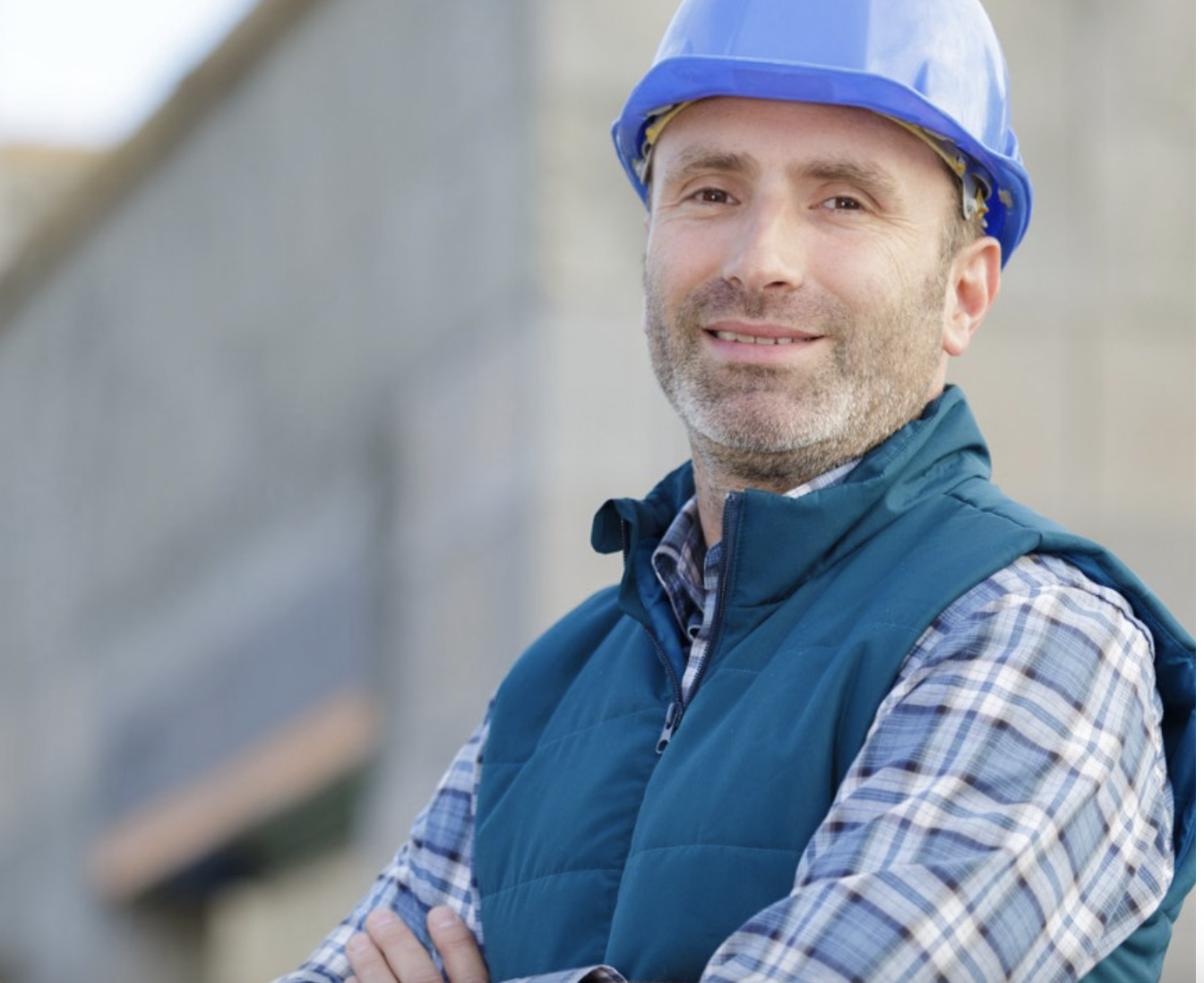 a man wearing a hard hat and vest