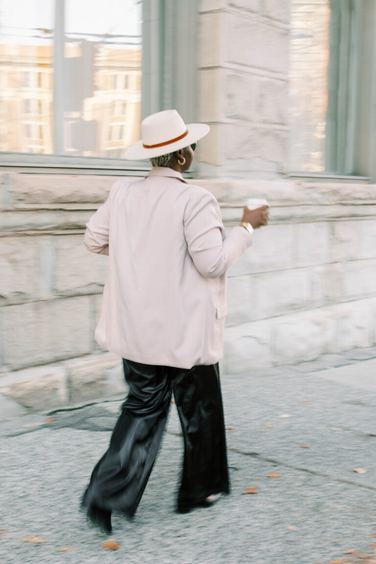 a woman walking down the sidewalk