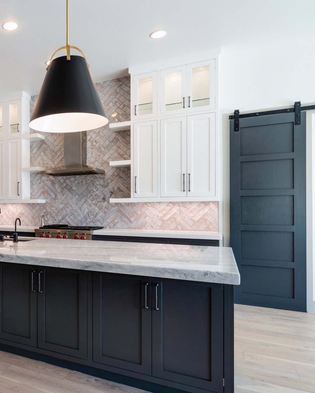 a kitchen with a black and white kitchen island