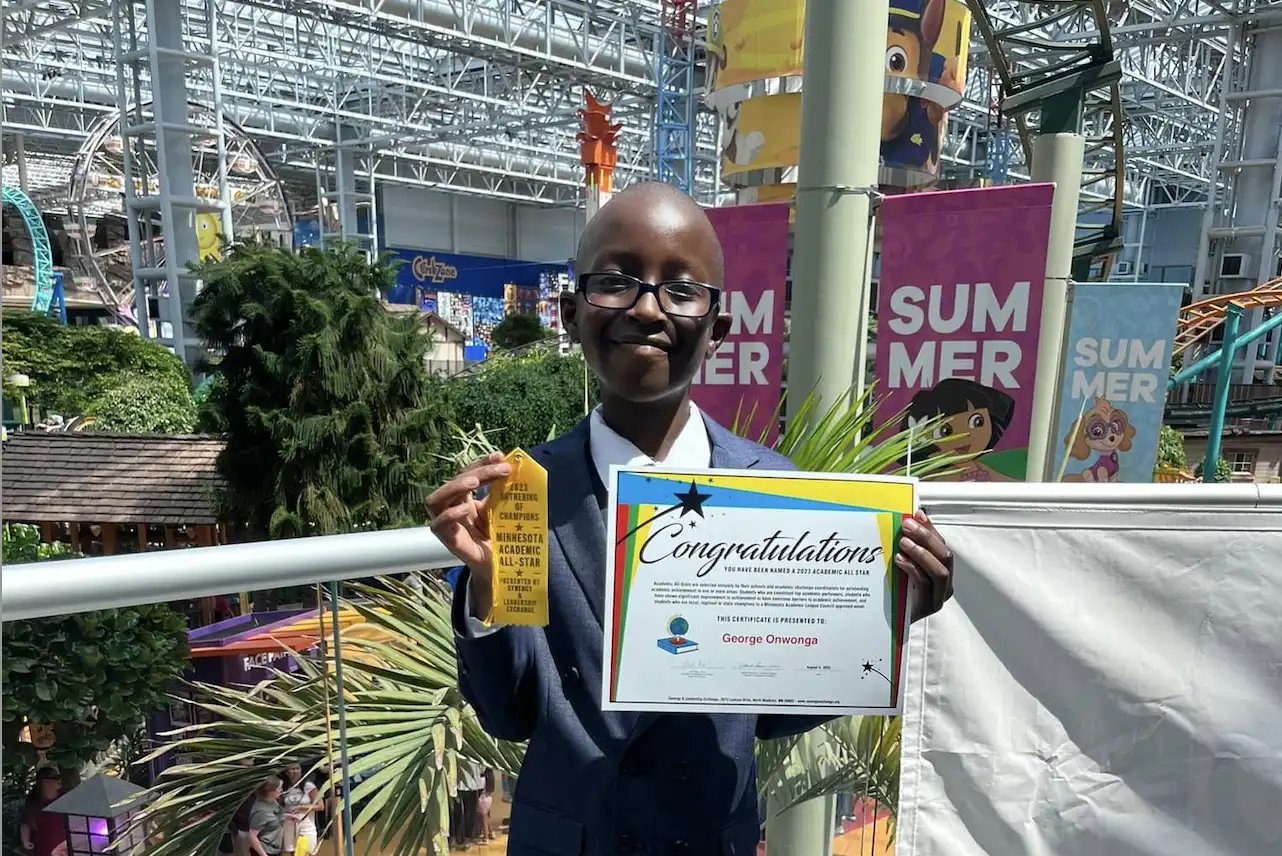 a boy holding a certificate