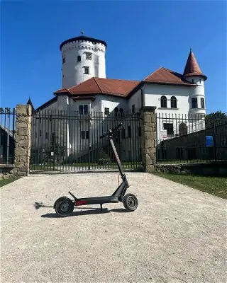 a scooter in front of a white building